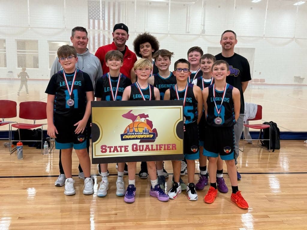 Legends team with medals holding the State Qualifier banner